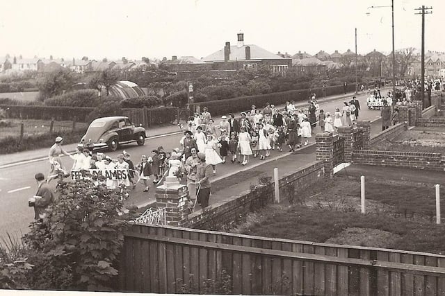 A gala procession approaches the home of Annette and Frank Hobbs in Bispham Road, Bispham in the early 1950s. Bispham Library can be seen in the distance