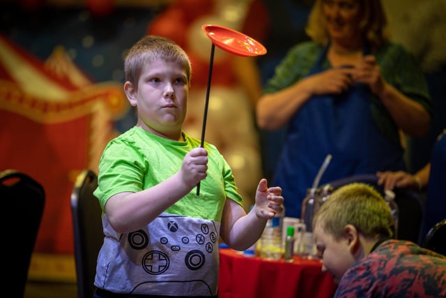 This young man practises the skills of plate-spinning at the young carers' party at Blackpool Tower