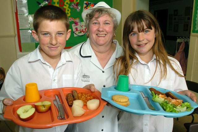 Waterloo School catering unit manager Eileen Crossan with pupils David Iles and Micha McGawley in 2005