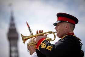 A bugle is played during a poignant moment  in the Blackpool  ceremony marking the 40th anniversary of the Falklands War,  the famous Tower  in the background