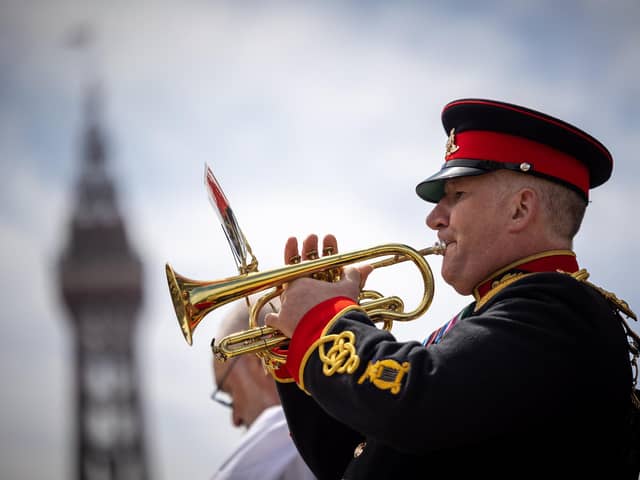 A bugle is played during a poignant moment  in the Blackpool  ceremony marking the 40th anniversary of the Falklands War,  the famous Tower  in the background