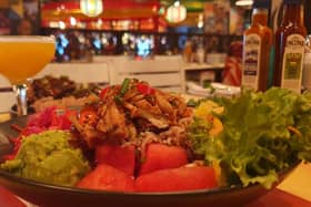 Succulent pulled jackfruit topped with our rum BBQ sauce, over fresh salad, tropical fruit, & rice & peas