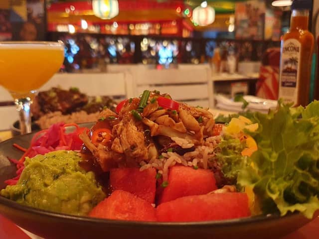 Succulent pulled jackfruit topped with our rum BBQ sauce, over fresh salad, tropical fruit, & rice & peas