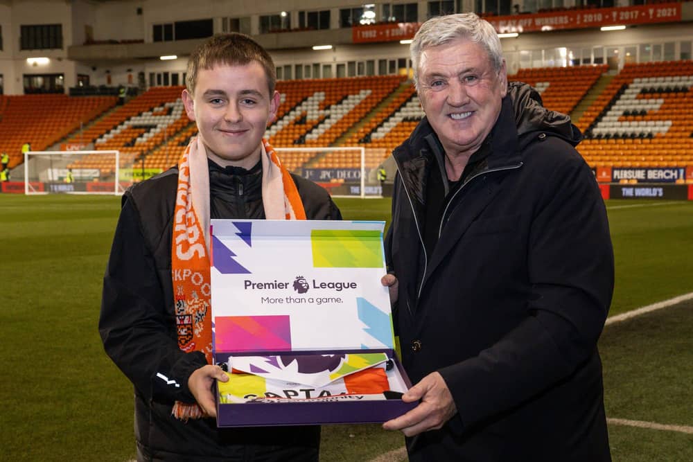 Blackpool FC Community Trust's Premier League community captain Joe Wallis is presented with his prize by Blackpool head coach Steve Bruce Picture: Craig Thomas/News Images via Blackpool FC Community Trust
