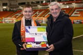Blackpool FC Community Trust's Premier League community captain Joe Wallis is presented with his prize by Blackpool head coach Steve Bruce Picture: Craig Thomas/News Images via Blackpool FC Community Trust
