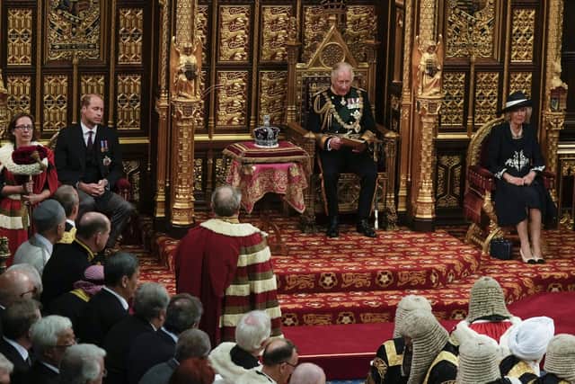The Prince of Wales, , flanked by the Duke of Cambridge and the Duchess of Cornwall, delivers the Queen's Speech during the State Opening of Parliament in the House of Lords, London