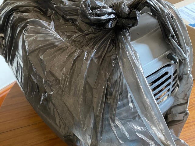 Carrier left covered with a bin bag.