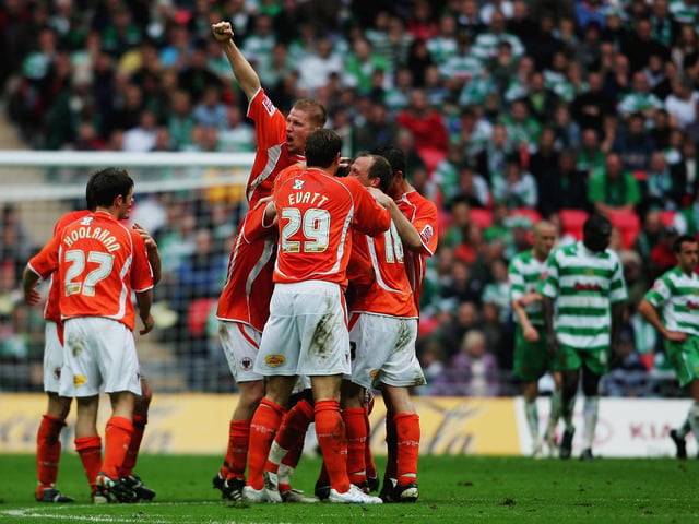 The Blackpool squad celebrate.