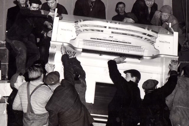 Workmen manhandle the famous Wurlitzer on its way back to the Tower Ballroom stage in 1958 following its reopening after the fire of December 1955