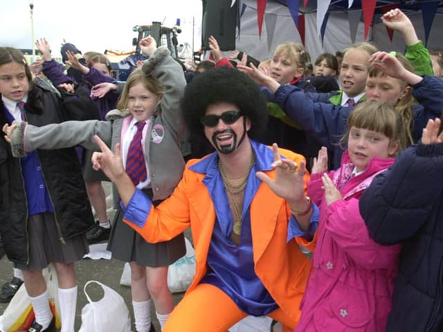Lionel Vinyl joins in with Bispham Endowed Primary School choir on the sea front at Blackpool 2000 Festival of Music
