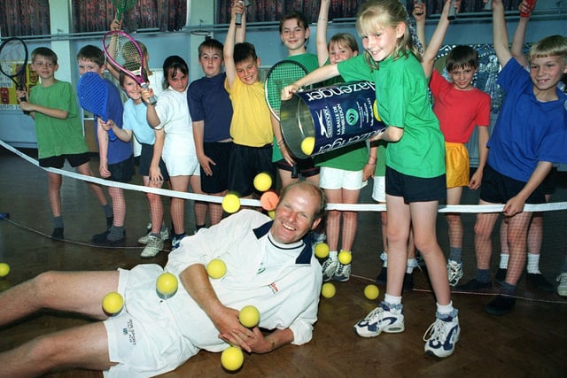 St Annes Tennis Club professional coach Bruce Garner with some of the children he was coaching at Heyhouses C of E Primary School in 1997