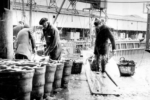 Dockers unloading a catch of fish at Fleetwood dock in 1989