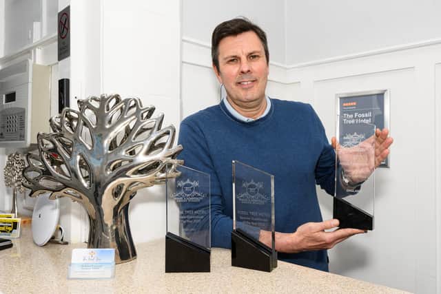 Owner of The Fossil Tree Hotel Chris Rinder with his award for Seaview Hotel of Year 2022. Photo: Kelvin Stuttard