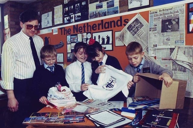 Mereside Primary School teacher Robin Thomson helps pupils pack a box for a Dutch exchange school with pupils Daniel Harris, Claire Green, Kelly Roberts and Michael Taylor