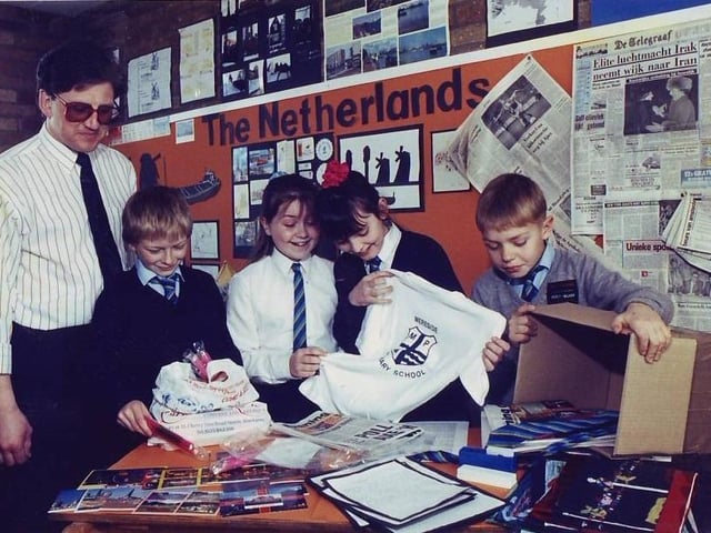 Mereside Primary School teacher Robin Thomson helps pupils pack a box for a Dutch exchange school with pupils Daniel Harris, Claire Green, Kelly Roberts and Michael Taylor