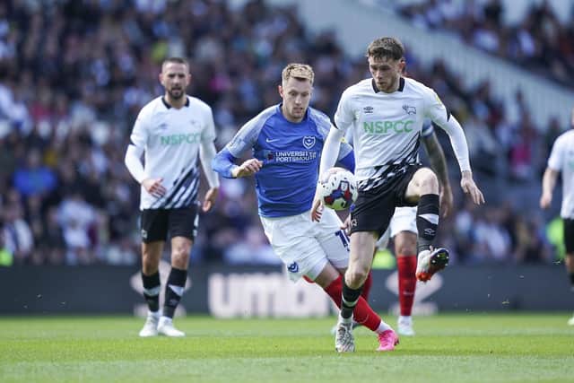 Joe Pigott pressures Derby's Max Bird in the first half of their Pride Park clash. Picture: Jason Brown/ProSportsImages