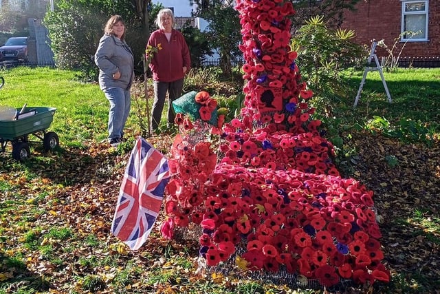Giant 'yarnbomb' mural created with hundreds of knitted and crocheted poppies for remembrance day.