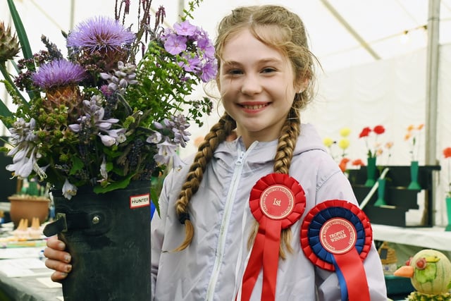 Freya Burton, 11, with her award-winning floral display in a wellington boot, which impressed the judges.