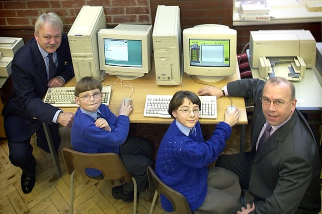 Two computers were donated by Parkinson's Builders for their new computer suite. Head Philip Whiteley, Sam Birchall (8), Jade Birch (9), and Managing Director of Parkinson's Peter Glenn in 2001