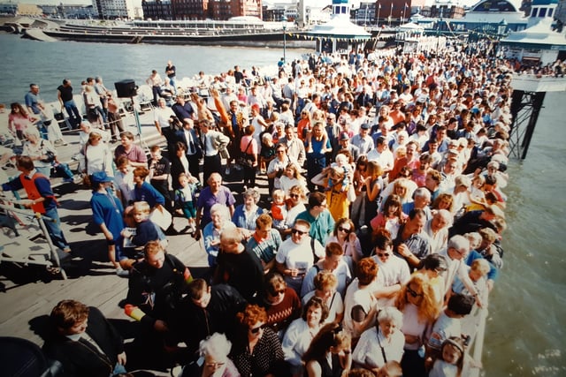 The crowds pack the pier to lend their support to wacky aviators