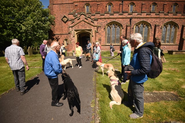 People affected by Mr Wildish's decades-long charitable efforts gathered at the church with an honour guard of guide dogs.