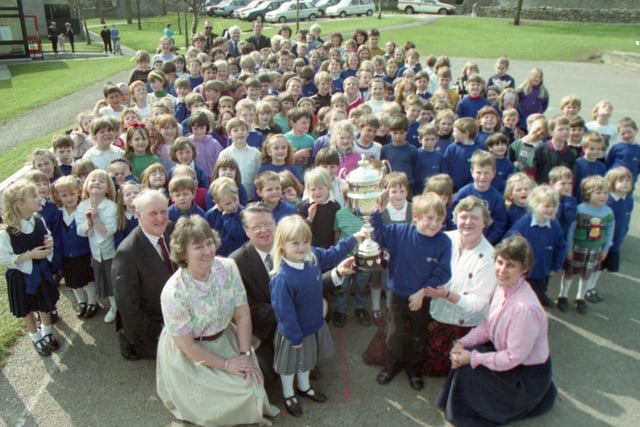 A school near Carnforth has scooped a road safety award, beating off competition from the rest of the county. The magnificent trophy, donated to the county council by the RAC in 1985, was awarded to Warton Archbishop Hutton Primary School by deputy county road safety organiser Mr Ken Ashby. Pupils Carly Boak, six, and Matthew Wetherill, five, received the trophy watched by fellow pupils