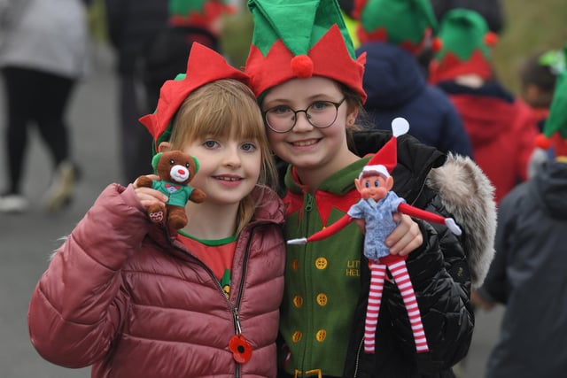 It's the latest elf run at Chaucer Primary School in Fleetwood - and these two youngsters have even brought along toys dressed for the occasion. Photo: Neil Cross;