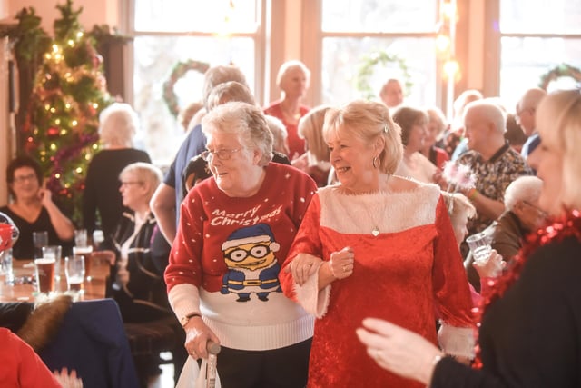 Founder Bev Sykes (right) with a happy members as Just Good Friends celebrates Christmas at the Victoria pub.