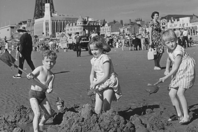 It's what it's all about - a group of children building sandcastles on the beach in 1965