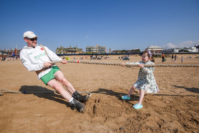 Alan Knott from the Tug of War Association struggles to compete with four-year-old Florence Woods.