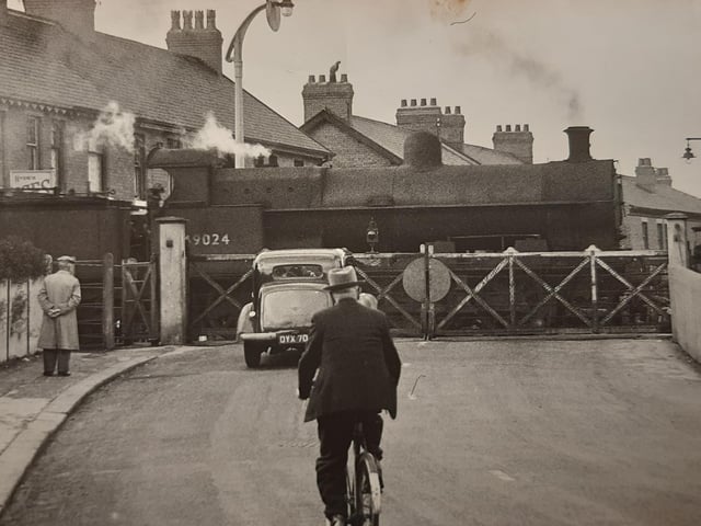 Not a sight you will see anymore - gates are down at the level crossing in Thornton as a steam train makes its entrance in 1929