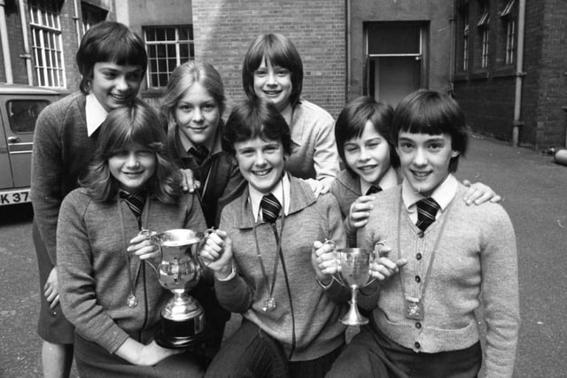 Seven somersaulting Lancashire lasses leapt to national gymnastic success in 1979. The group from Lytham St Annes High School proved too good for hundreds of schools all over Britain, to take the prestige of junior gym title. Pictured with their trophies, which were presented to them at Lancashire County Hall, are: Back: Nicola Travoni, 12, Belinda Shorrock, 13, Donna Gregory, 12, Rosemarie Willder, 12. Front: Anita Rigby, 13, Sharon Morgan, 13, and Julie-Anne Phillips, 13