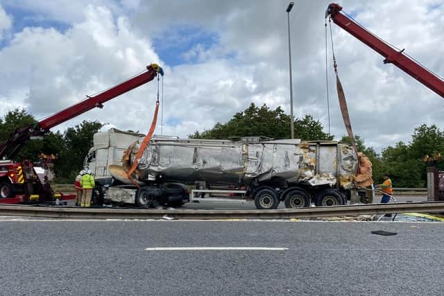 The milk tanker is righted on the M6 near Preston after the incident (Credit: National Highways)