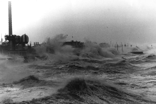 The promenade battered by huge waves. taken from the open air pool looking towards the Pleasure beach. The roof of the Star Inn can just be seen near the centre