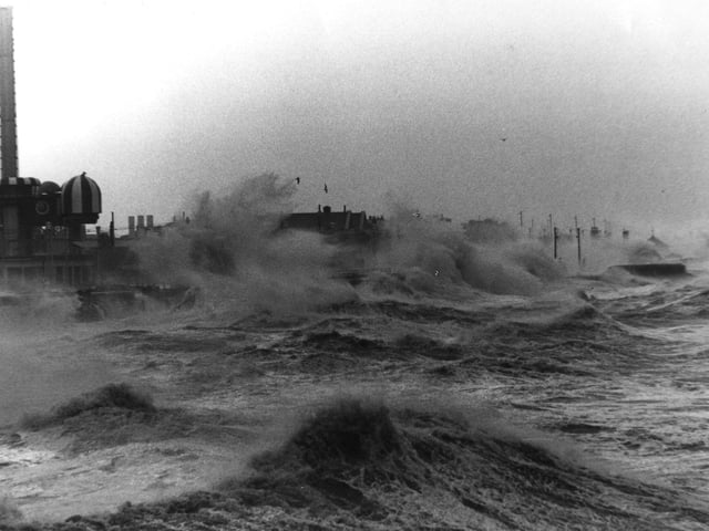 The promenade battered by huge waves. taken from the open air pool looking towards the Pleasure beach. The roof of the Star Inn can just be seen near the centre