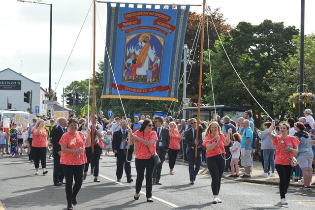 Members of the community take part in the Freckleton Club Day procession through the village.