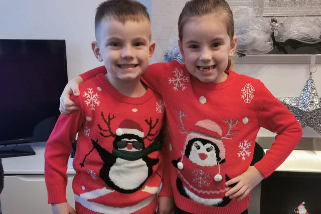 Arlie, age 5, and Marcie, age 6, in their penguin Christmas jumpers.