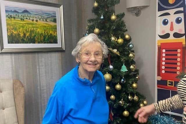 Resident after decorating the Christmas tree