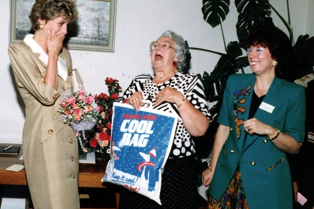 Princess Diana shares a joke with the ladies at Relate as she accepts a bag of gifts-including some Fleetwood Fish