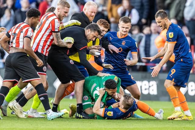 Shayne Lavery is taken to ground by Sheffield United's goalkeeper Wes Foderingham