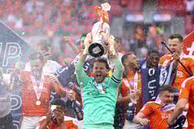 LONDON, ENGLAND - MAY 30: Chris Maxwell of Blackpool lifts the Sky Bet League One Play-off Trophy as his team mates celebrate following victory in the Sky Bet League One Play-off Final match between Blackpool and Lincoln City at Wembley Stadium on May 30, 2021 in London, England. (Photo by Catherine Ivill/Getty Images)