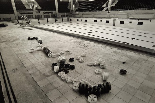 Lane dividers discarded at the side of the pool in this photo