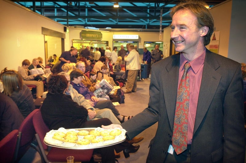 Airport Managing Director Garry Eastwood hands out mince pies to a packed departure lounge on Christmas Eve