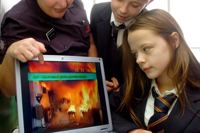 Palatine High School launch of Key Stage 3 Fire Smart campaign. Community Fire Safety Officer Karen Friday shows a video of the rapid development of a front room fire, to pupils Harrison Briggs and Emma Allen, 2006