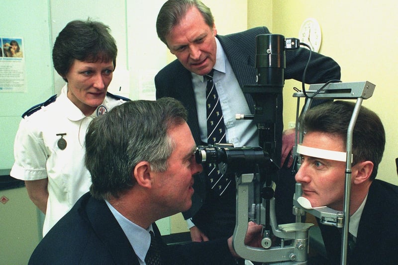 Professor Andrew R. Elkington (President of the Royal College of Ophthalmologists)  opened the new Ophthalmic Day Case Unit at Blackpool's Victoria Hospital. Mr James Dunne (left), Clinical Director - Ophthalmology (Victoria Hospital) is pictured using a Slit-Lamp Microscope on Business Manager  Alex Virtue, watched by Sister in Charge  Anne McSpirit.