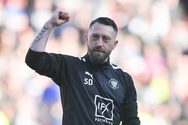 Dobbie celebrates with the fans at full time
