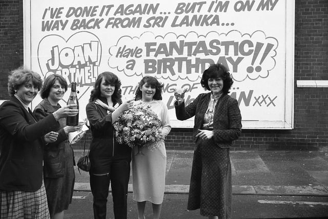 Brian Cartmell's special birthday card to his wife wouldn't quite fit through the letter box. In fact, it probably would have taken a dozen postmen to even lift it. Brian's wife Joan got the surprise of her life when she saw her husband's birthday greetings splashed over a 23ft wide hoarding behind Blackpool's Winter Gardens complex. She is pictured above celebrating with friends