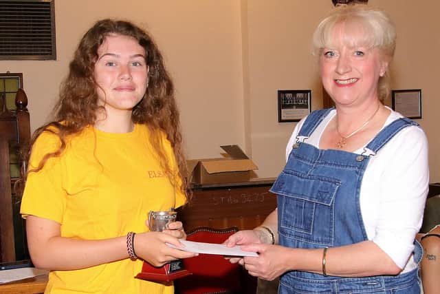 Liberty Doyle is presented with her Jan Kemball prize by Jan's daughter Alexandra.