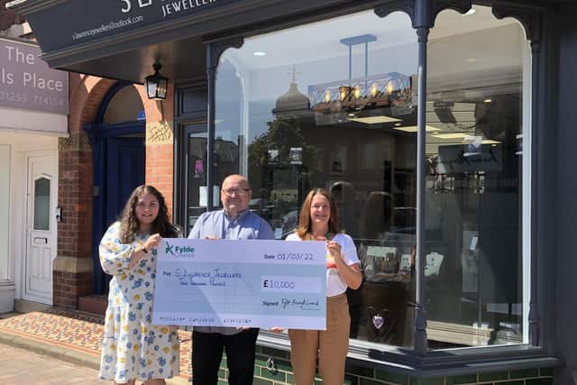 Jeweller Steve Wellings and daughter Emily are presented with the ARG cheque by Fylde Council leader Coun Karen Buckley outside the new premises in St Annes.