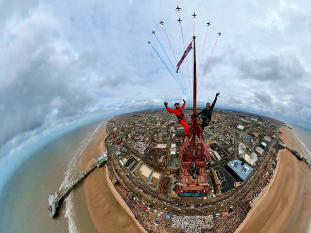 Adam Collins, Officer Commanding the Red Arrows, was at the top of the flag pole on the tower saluting them as they flew past. See SWNS story SWMRtower. 
